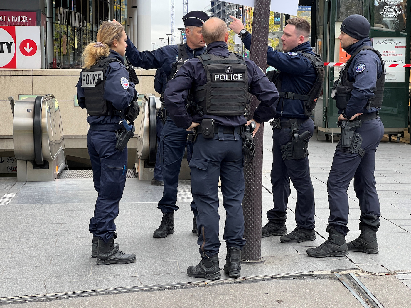Police stand outside the Bibliotheque Francois Mitterrand metro and regional train station in Paris, France, October 31, 2023. (Reuters)