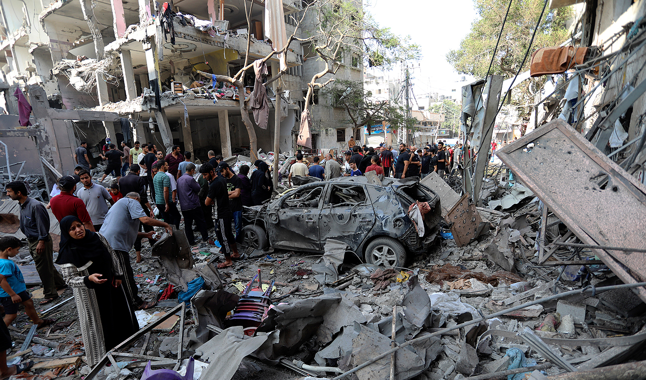 Palestinians inspect the damage of buildings that were hit by Israeli airstrikes, in a refugee camp, in Gaza City, Tuesday, Oct. 31, 2023. (AP)