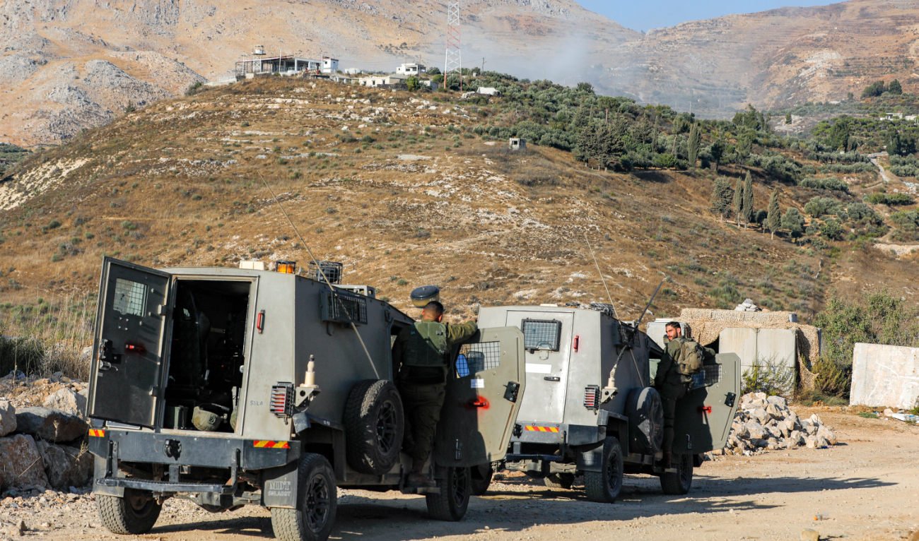 Israeli military vehicles deployed in Majdal Shams in Golan Heights as smoke billowed from a Syrian position after Israeli bombardment in September. (AFP)