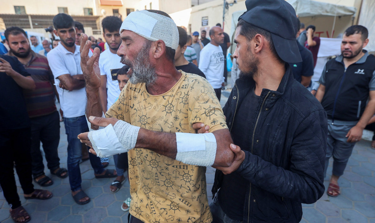 A Palestinian man, who was wounded in an Israeli strike and said that he lost his father, son and brother in the strike, reacts at Shuhada Al-Aqsa hospital in the central Gaza Strip October 31, 2023. (Reuters)