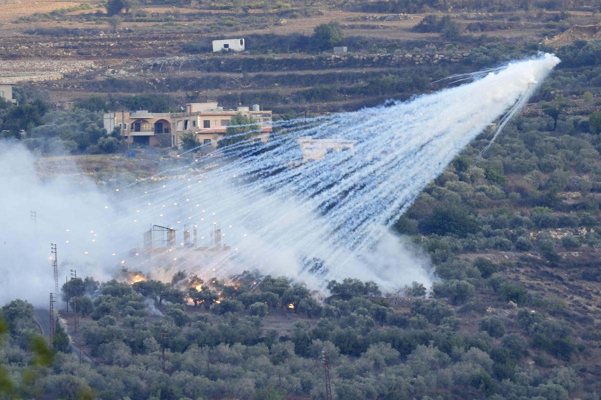 A shell that appears to be white phosphorus from Israeli artillery explodes over a house in al-Bustan, a Lebanese border village with Israel, south Lebanon, on Oct. 15, 2023. (AP)