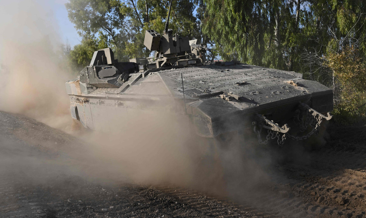 An Israeli tank rolls towards the border with Gaza Strip at an undisclosed location in southern Israel on Oct. 15, 2023. (AFP)