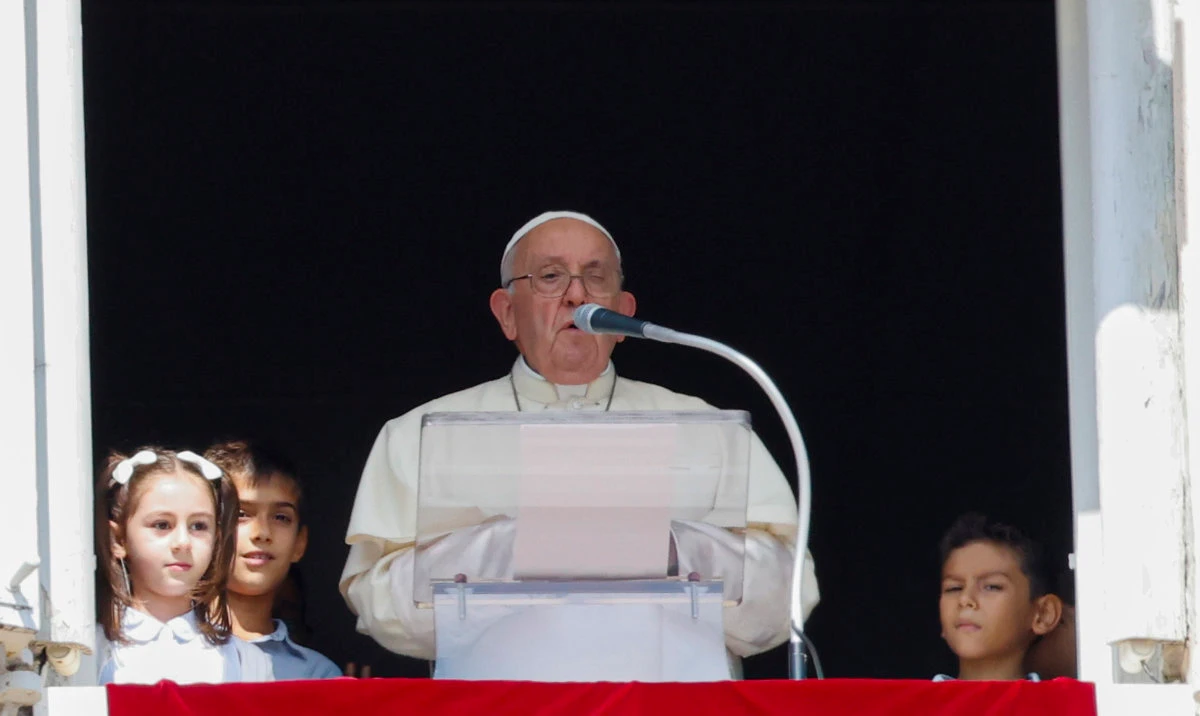 Pope Francis, flanked by children from the five continents, speaks from his studio's window to the faithful gathered for the traditional Sunday's noon blessing in St. Peter's Square at The Vatican, Sunday, Oct. 1, 2023. (AP)