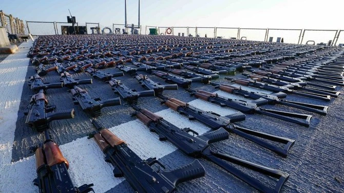Thousands of AK-47 assault rifles are seen on the flight deck of guided-missile destroyer USS The Sullivans during an inventory process, after they were seized from a fishing vessel in international waters of the Gulf of Oman in December 2022. Also seized were more than a million rounds of bullets. (US Navy via AFP/File)