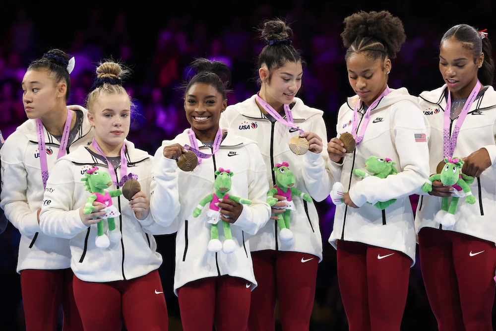 Team USA look at their medals as Simone Biles smiles, third left, after the women's team final at the Artistic Gymnastics World Championships in Antwerp, Belgium, Wednesday. (AP)