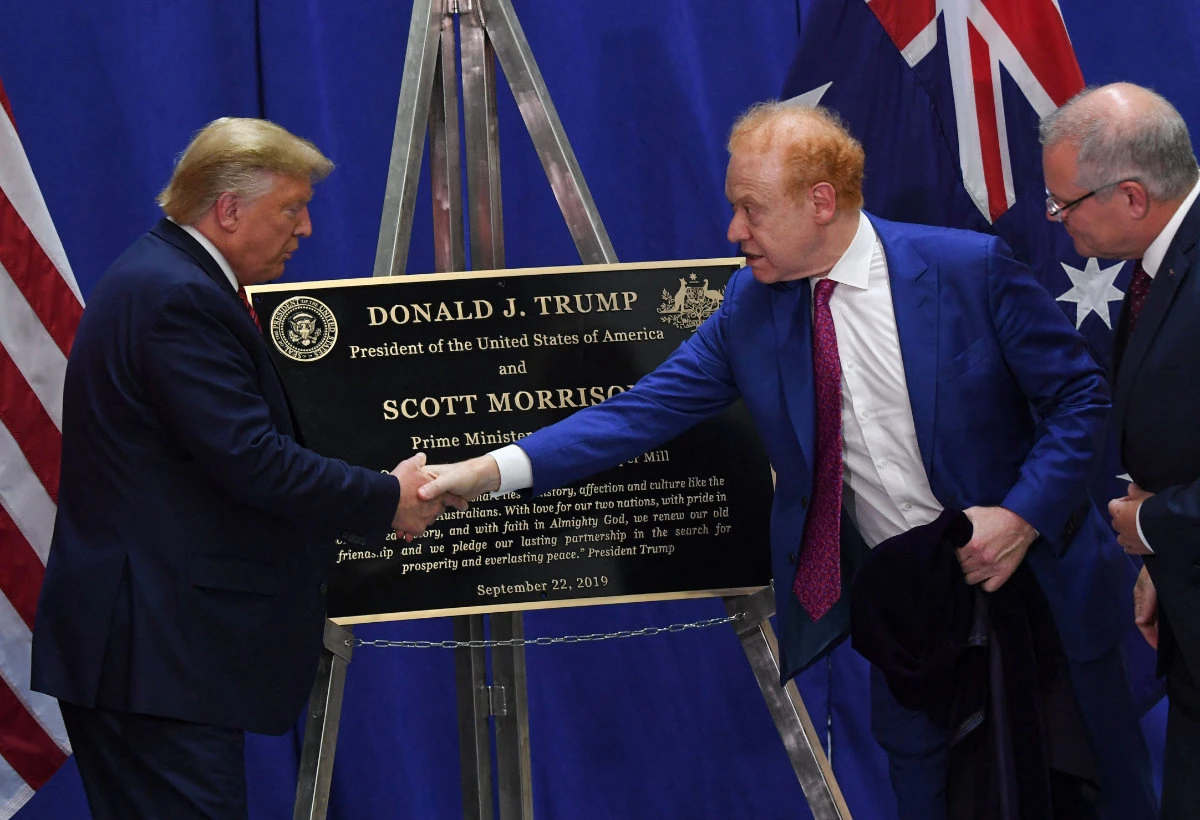 US President Donald Trump (L) shakes hands with Global Chairman of Pratt/Visy Industries Anthony Pratt (2R) as Australian Prime Minister Scott Morrison looks on during a visit to Pratt Industries plant opening in Wapakoneta, Ohio on September 22, 2019. (AFP/File)