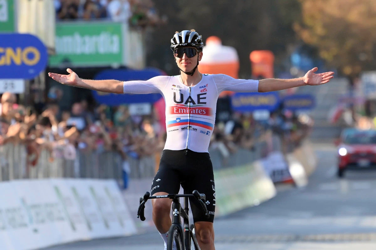 Tadej Pogacar celebrates as he crosses the finish line to win the Tour of Lombardy cycling race, from Como to Bergamo, Italy, on Saturday. (AP)