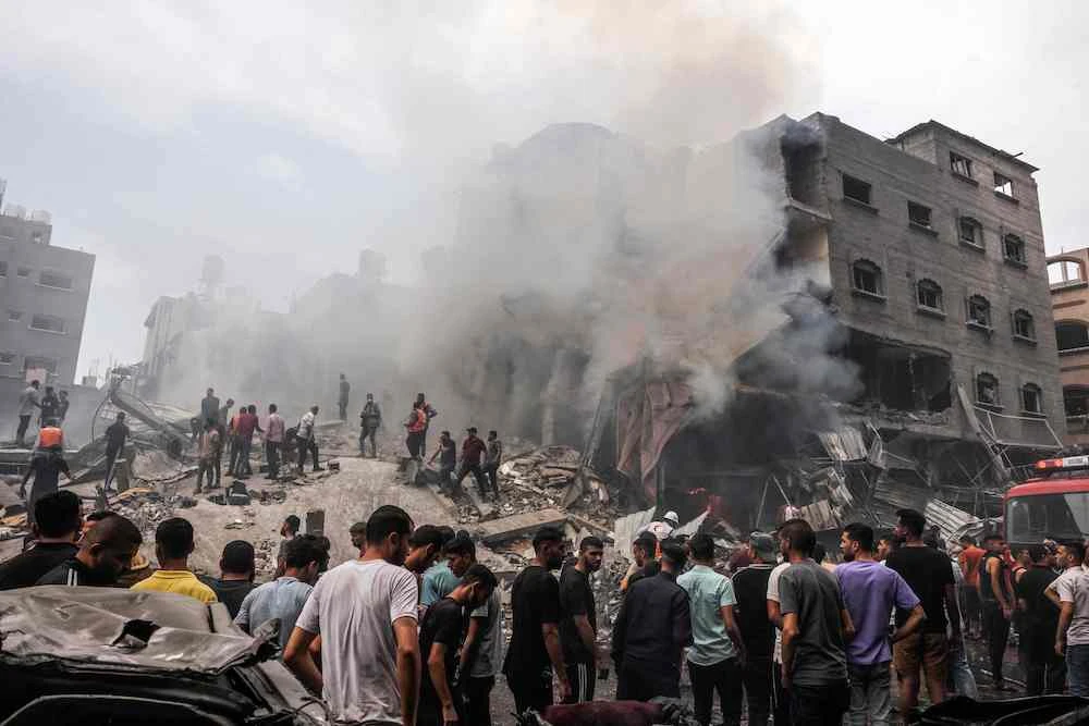 Palestinians search for survivors after an Israeli air strike on buildings in the refugee camp of Jabalia in the Gaza Strip on Oct. 9, 2023. (AFP)