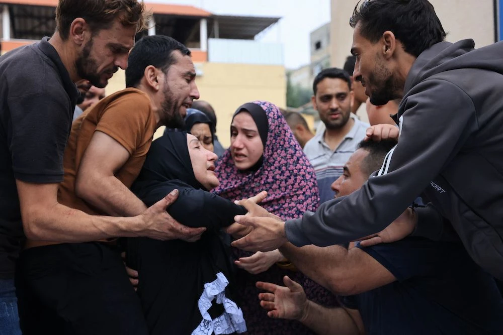 At least nine Americans could be among over 1,000 casualties from the fighting between Israeli forces and Hamas militants. Above, Palestinians mourn the death of their relatives following an Israeli air strike on the refugee camp of Jabalia in the Gaza Strip on Oct. 9, 2023. (AFP)