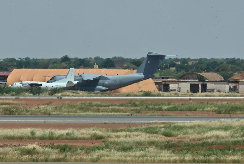 France has begun withdrawing its troops from Niger after being ordered out of the West African nation by the leaders of the July coup. Above, a French air force plane at the French air base in Niamey. (AFP)