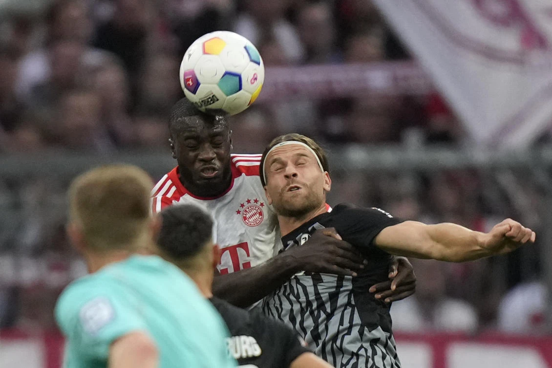 Bayern’s Dayot Upamecano and Freiburg’s Lucas Hoeler challenge for the ball during their Bundesliga match at the Allianz Arena stadium in Munich on Oct. 8, 2023. (AP)