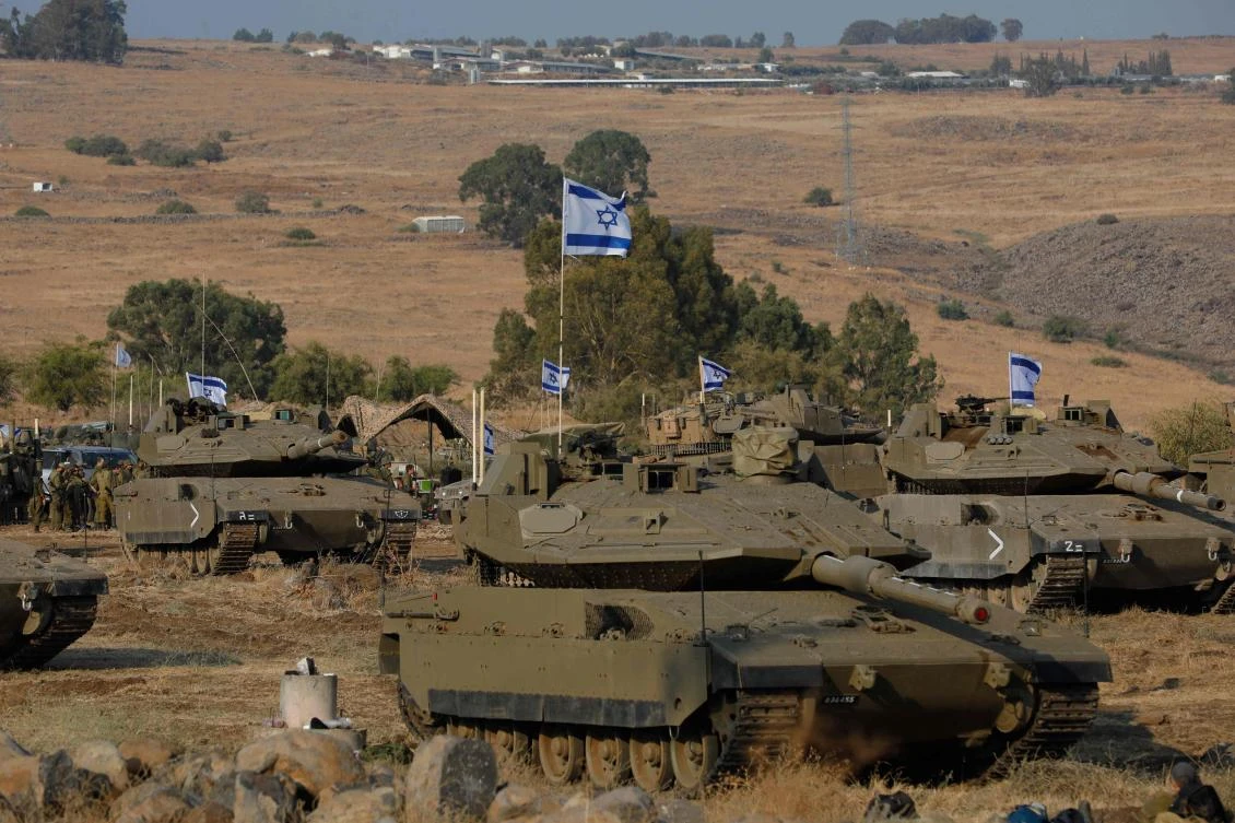 Israel appeared to be readying for a possible ground invasion of Gaza, but faces the threat of a multi-front war after also coming under rocket attack from militant groups in neighboring Lebanon and Syria. (AFP)