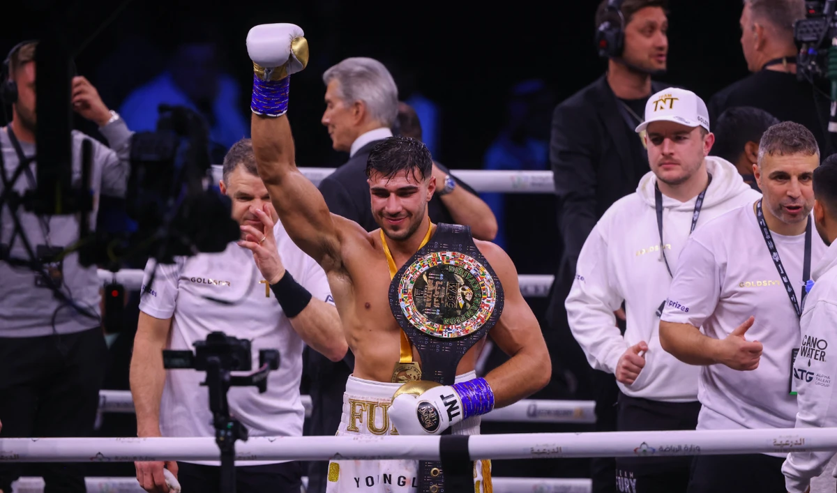 British reality TV star Tommy Fury (C) celebrates after he won by split decision against US YouTuber Jake Paul in a boxing match held at Diriyah in Riyadh, Saudi Arabia on Feb. 27, 2023. (AFP)