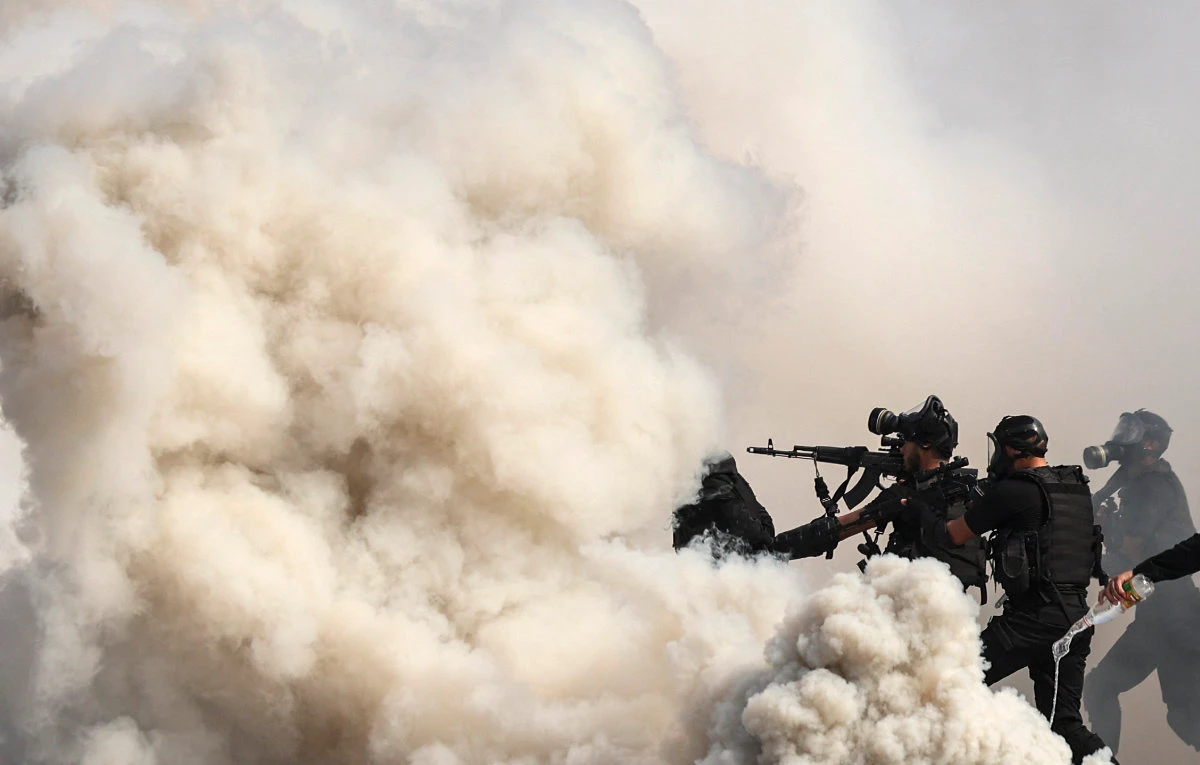 Members of the Palestinian security forces loyal to Hamas show their skills during a graduation ceremony in Gaza City on February 21, 2022. (AFP)