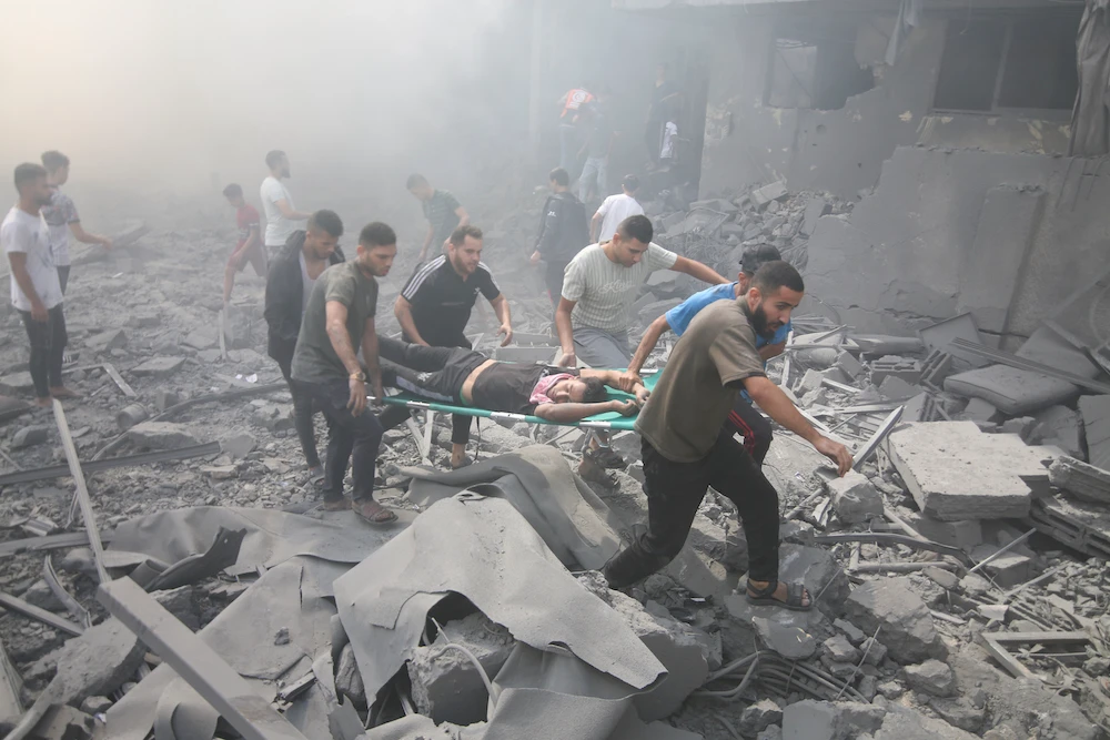 Palestinians evacuate wounded after an Israeli airstrike in Rafah refugee camp, southern Gaza Strip, Thursday, Oct. 12, 2023. (AP)