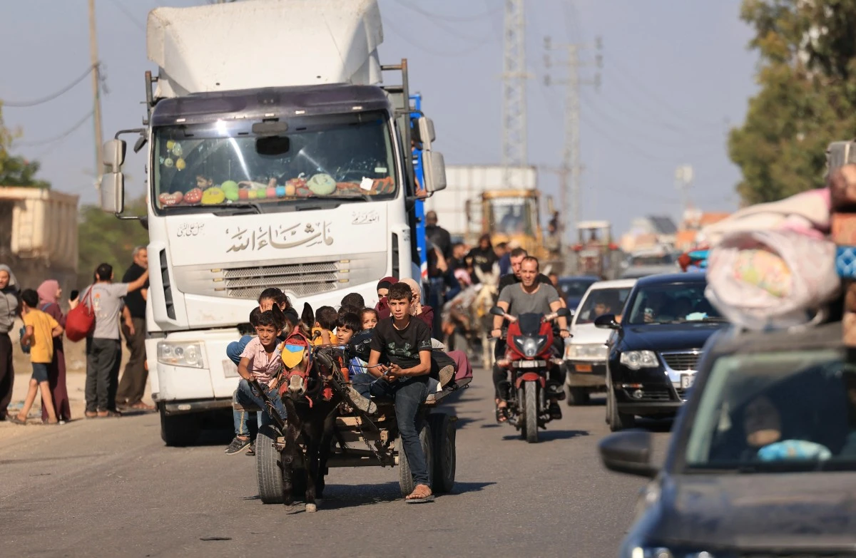 Riding a donkey drawn cart as family along with hundreds of other Palestinian carrying their belongings flee following the Israeli army's warning to leave their homes and move south before an expected ground offensive, in Gaza City on October 13, 2023. (File/AFP)