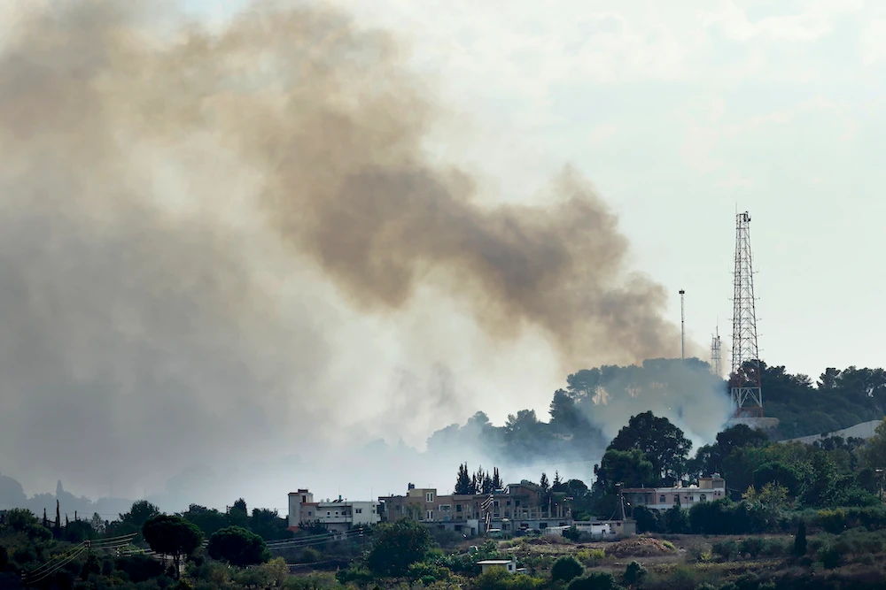 Above, smoke rises from an Israeli army position which was attacked by Hezbollah fighters near Alma Al-Shaab, a Lebanese border village with Israel, on Oct. 15, 2023. (AP)