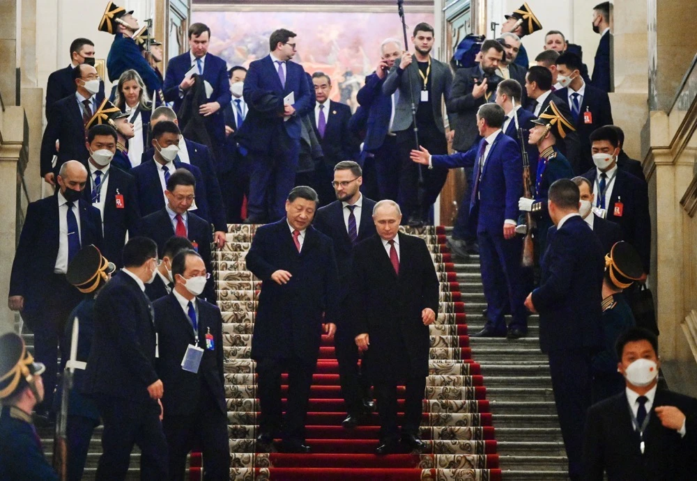 Russian President Vladimir Putin and China's President Xi Jinping leave after a reception following their talks at the Kremlin in Moscow on March 21, 2023. (AFP)