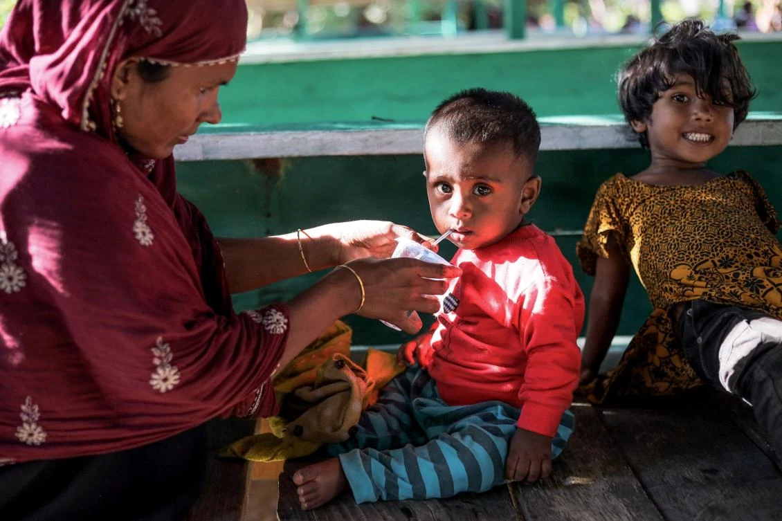 Rohingya refugees are placed in a temporary shelter for medical check up and food in Matang Pasi village, Bireun district, Aceh province on October 16, 2023. (AFP)