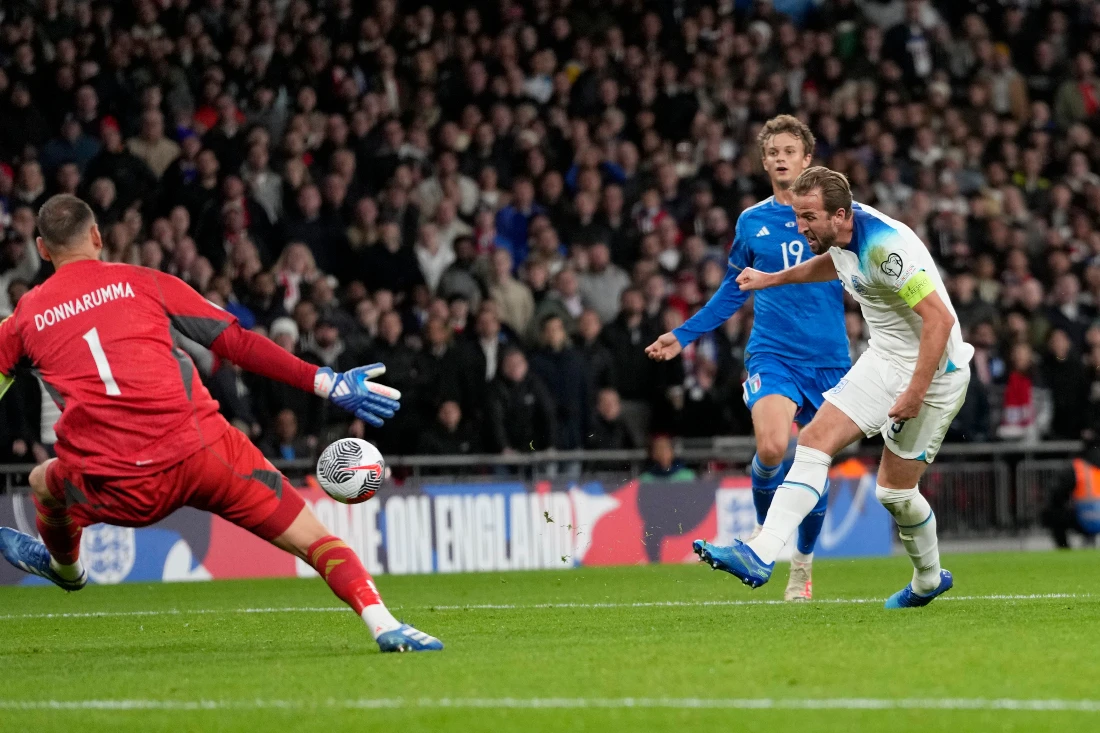 England's Harry Kane, right, scores his side's third goal during the Euro 2024 Group C qualifying soccer match between England and Italy at Wembley stadium in London. (AP)