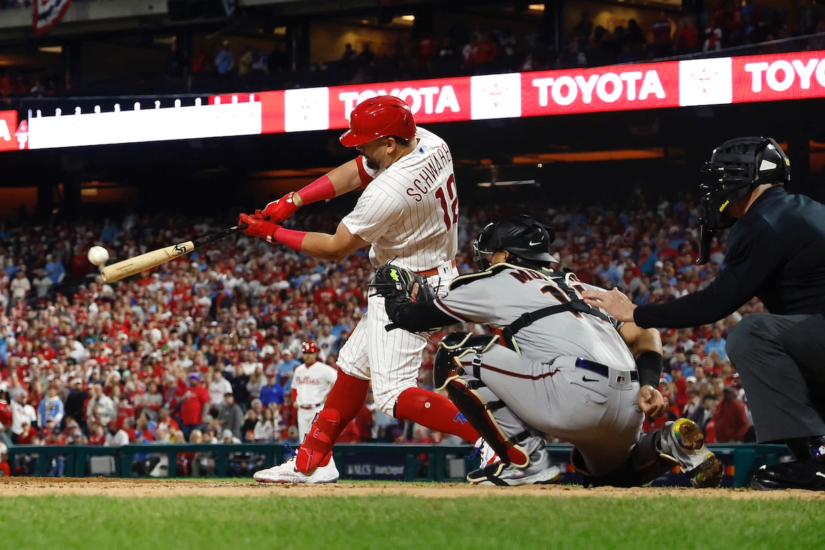 Kyle Schwarber #12 of the Philadelphia Phillies hits a home run in front of Gabriel Moreno of the Arizona Diamondbacks during Game 2 of the Championship Series at Citizens Bank Park on Tuesday in Philadelphia, Pennsylvania. (AFP)