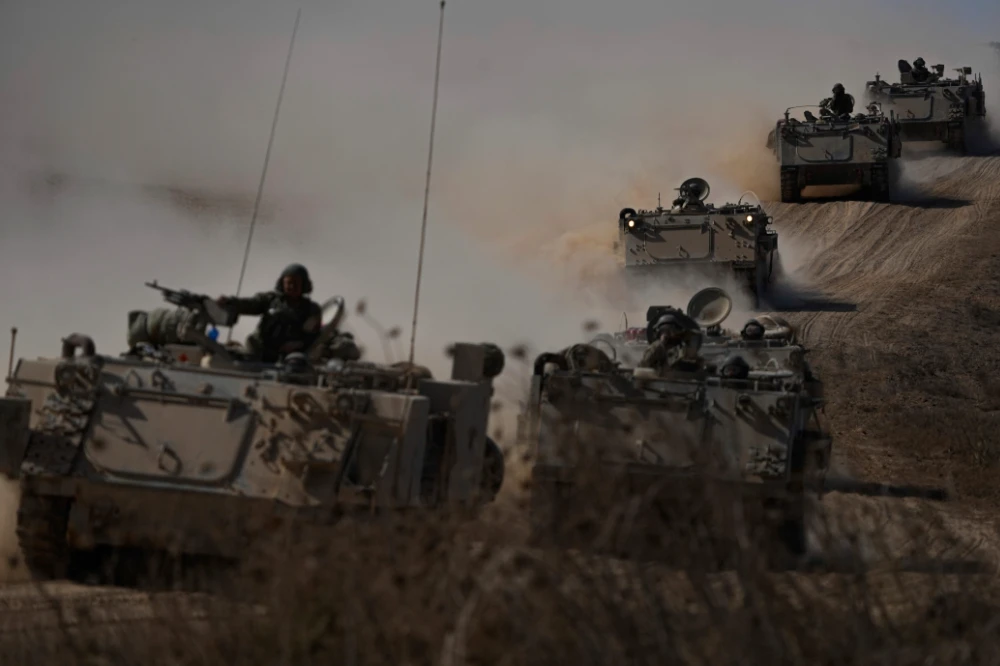 Israeli APCs head toward the Gaza Strip border in southern Israel. (AP)