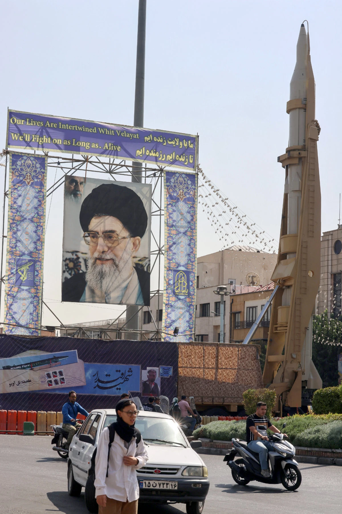 Iranian Sejil surface-to-surface missile are displayed on a main road next to a portrait of Ayatollah Ali Khamenei on the occasion of Iran's "Defense Week" at Baharestan Square in Tehran on September 27, 2023. (AFP)