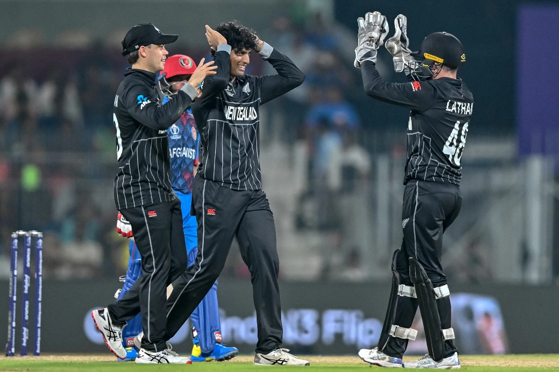 New Zealand's Rachin Ravindra (C) celebrates with teammates after taking the wicket of Afghanistan's Rahmat Shah during the 2023 ICC Men's Cricket World Cup. (File/AFP)