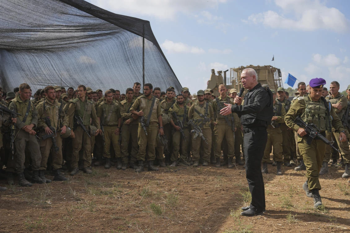 Israel's Defense Minister Yoav Gallant, wearing a protective vest, speaks with Israeli soldiers in a staging area near the border with the Gaza Strip in southern Israel. (File/AP)