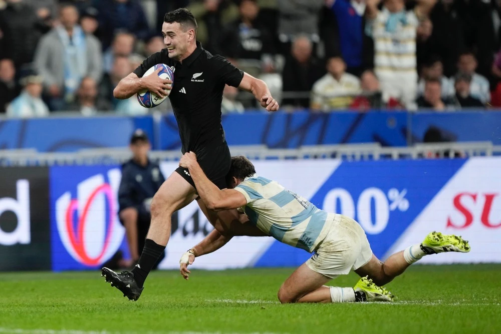 New Zealand’s Will Jordan, left, runs on his way to score a try as Argentina’s Juan Cruz Mallia tries to stop him during the Rugby World Cup semifinal match between Argentina and New Zealand at the Stade de France in Saint-Denis, outside Paris, Friday. (AP)