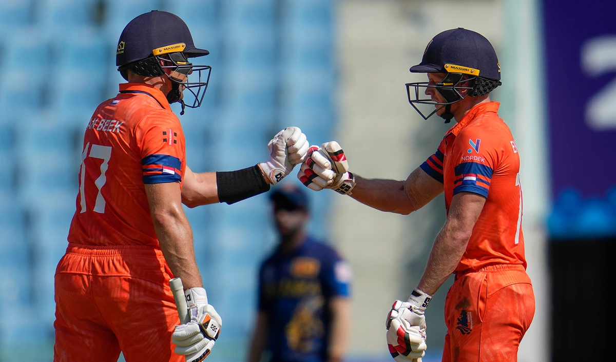 Netherlands' Sybrand Engelbrecht, right, and his batting partner Logan Van Beek bump fists as they bat during the ICC Men's Cricket World Cup match between Sri Lanka and Netherlands in Lucknow, India, on October 21, 2023. (AP)