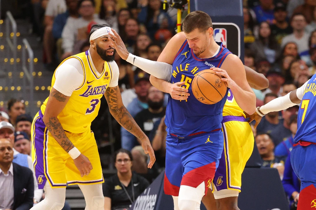 Nikola Jokic of the Denver Nuggets fights for a rebound against the Los Angeles Lakers in the second half of the NBA Opening night game at Ball Arena. (AFP)