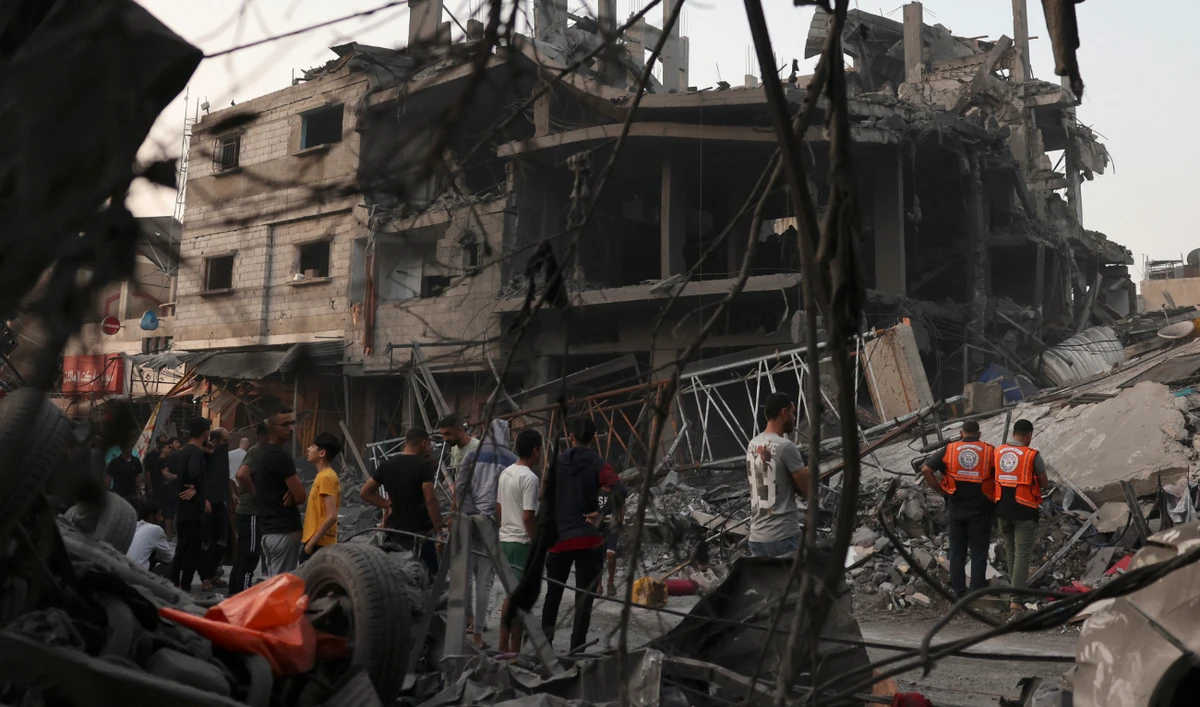 Palestinians inspect the rubble of a building following overnight Israeli strikes on the Rafah refugee camp in the southern Gaza Strip on October 25, 2023. (AFP)