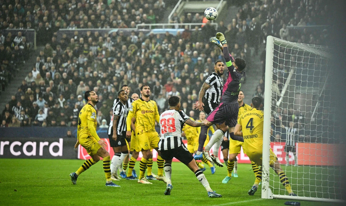 Dortmund's Swiss goalkeeper #01 Gregor Kobel jumps to save the ball during the UEFA Champions League Group F football match between Newcastle United and Borussia Dortmund at St James' Park in Newcastle-upon-Tyne, north east England, on October 25, 2023. (AFP)