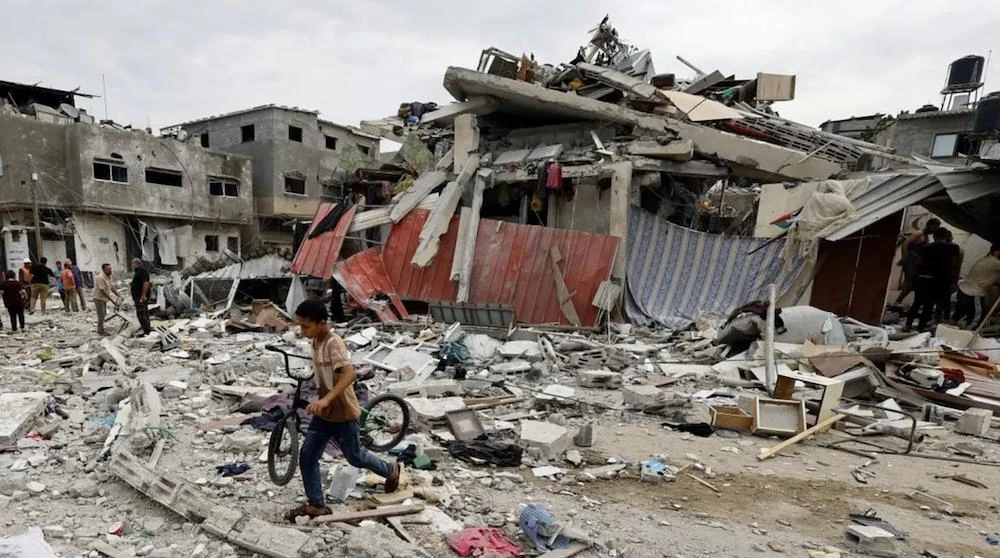 A child walks at the site of an Israeli airstrike on a house, as the conflict between Israel and Palestinian group Hamas continues, in Khan Younis in the southern Gaza Strip, October 27, 2023. (Reuters)