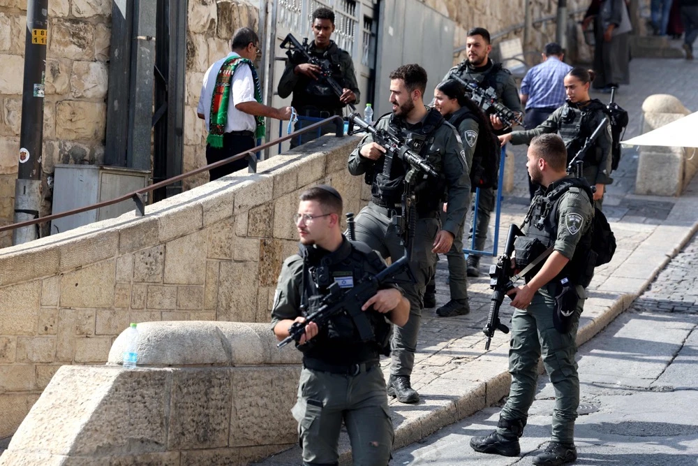 Israeli border police watch as Muslim worshippers arrive at the Lion's Gate to make their way to the the Al-Aqsa Mosque. (AFP)