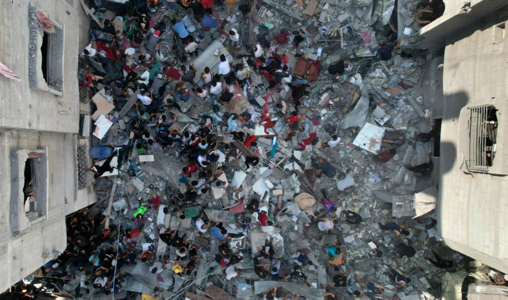 Palestinians look for survivors of an Israeli bombardment of the Gaza Strip in the Nusseirat refugee camp. (AFP)