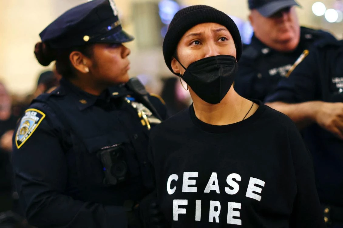 NYPD officers arrest protester during demonstration calling for a ceasefire amid war between Israel and Hamas, at Grand Central Station in New York City. (AFP)