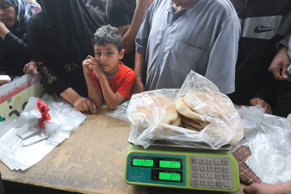 Palestinians wait to buy bread during the ongoing bombardment of the Gaza Strip in Rafah on Sunday, Oct. 29, 2023. (AP)