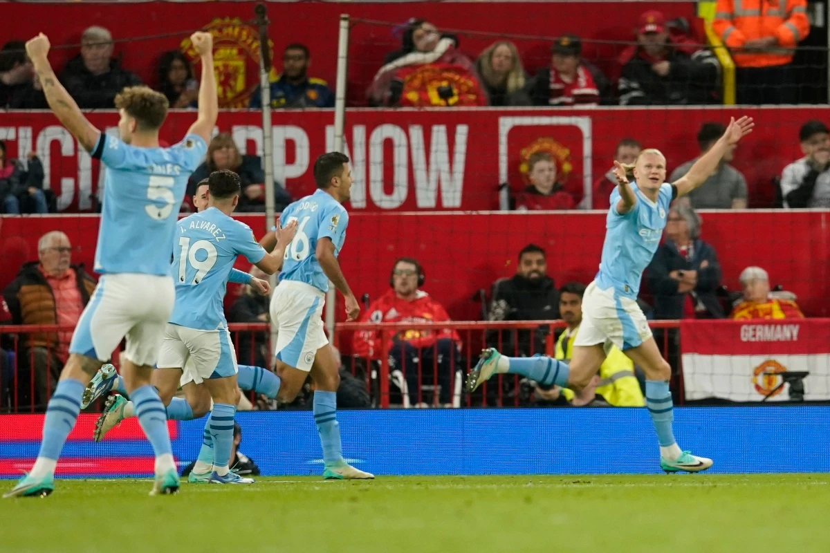 Manchester City's Erling Haaland, right, celebrates after scoring his side's second goal during the English Premier League soccer match against Manchester United at Old Trafford stadium in Manchester, England, Sunday. (AP)