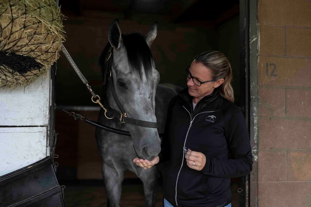 Trainer Jena Antonucci gives a treat to Arcangelo ahead of the Breeders’ Cup horse race at Santa Anita Park in Arcadia, Calif., Friday. (AP)