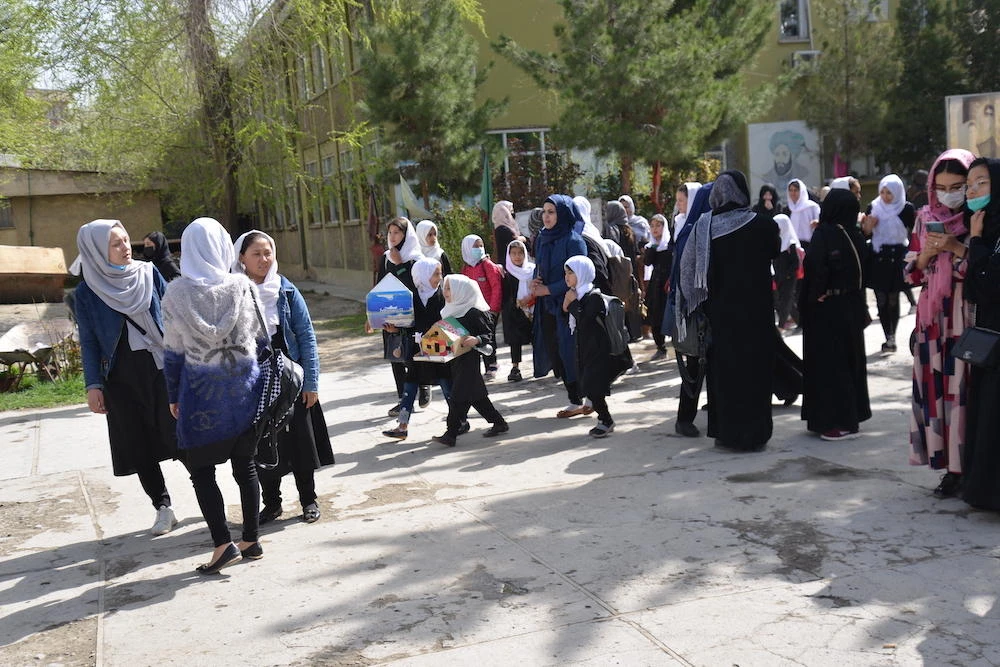 Above, Afghan girls leave their school following order of closure just hours after reopening in Kabul on March 23, 2022. (AFP)