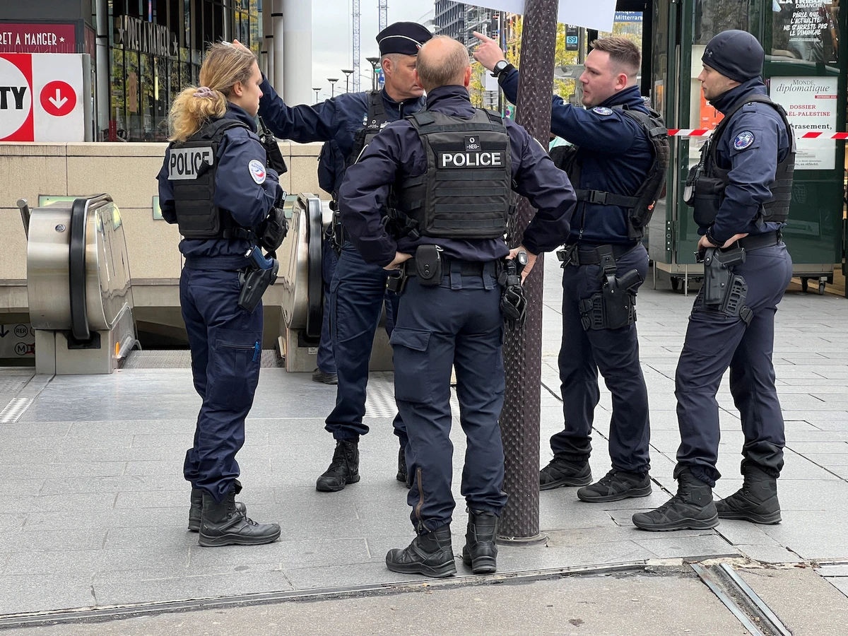 Police stand outside the Bibliotheque Francois Mitterrand metro and regional train station in Paris, France, October 31, 2023. (Reuters)