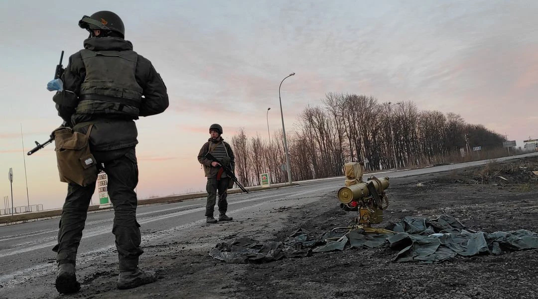 Service members of the Ukrainian armed forces stand next to a tripod-mounted missile system outside Kharkiv, Ukraine. (Reuters)