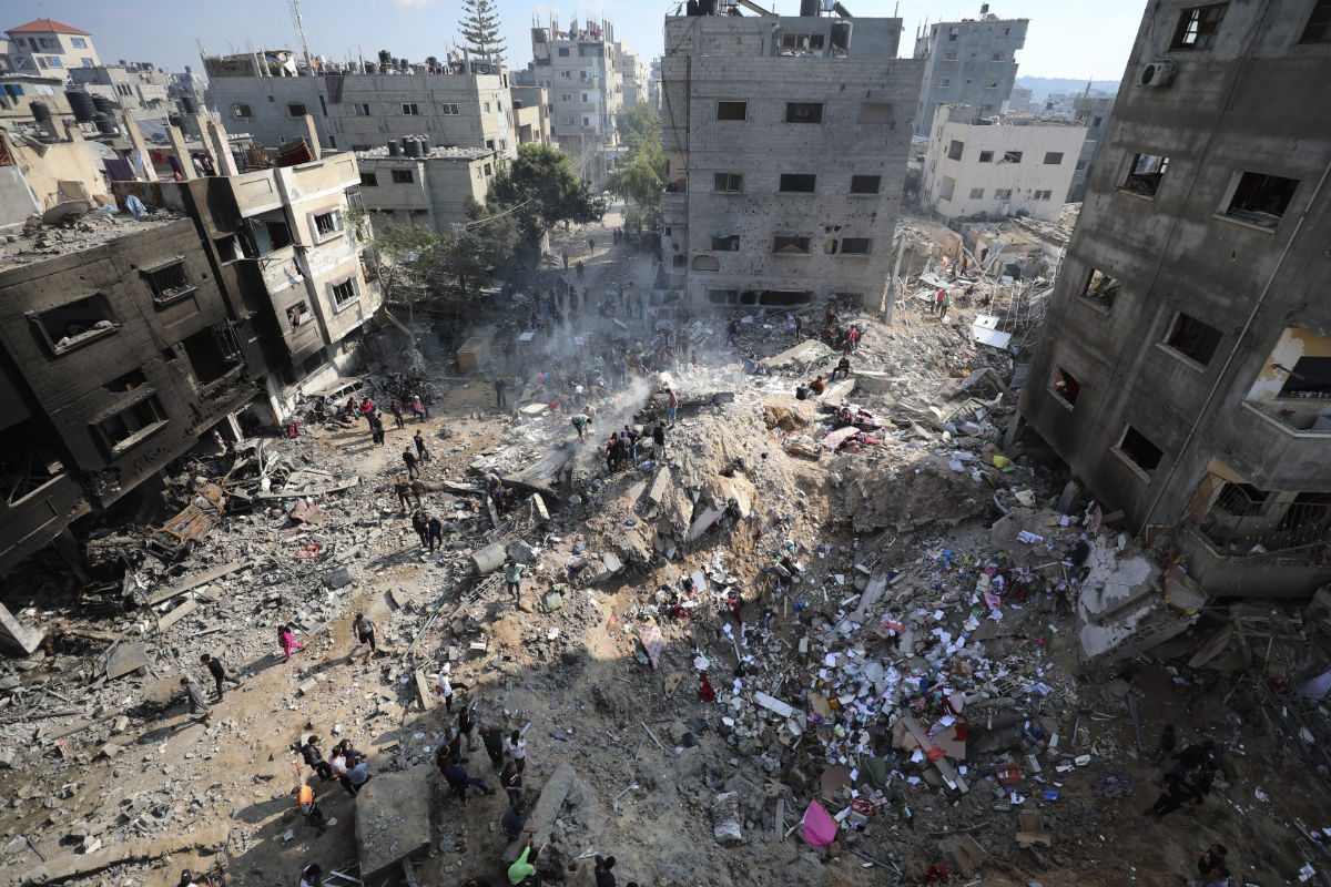 Palestinians look at destruction after an Israeli strike on the Gaza Strip in Nusseirat refugee camp. (AP)