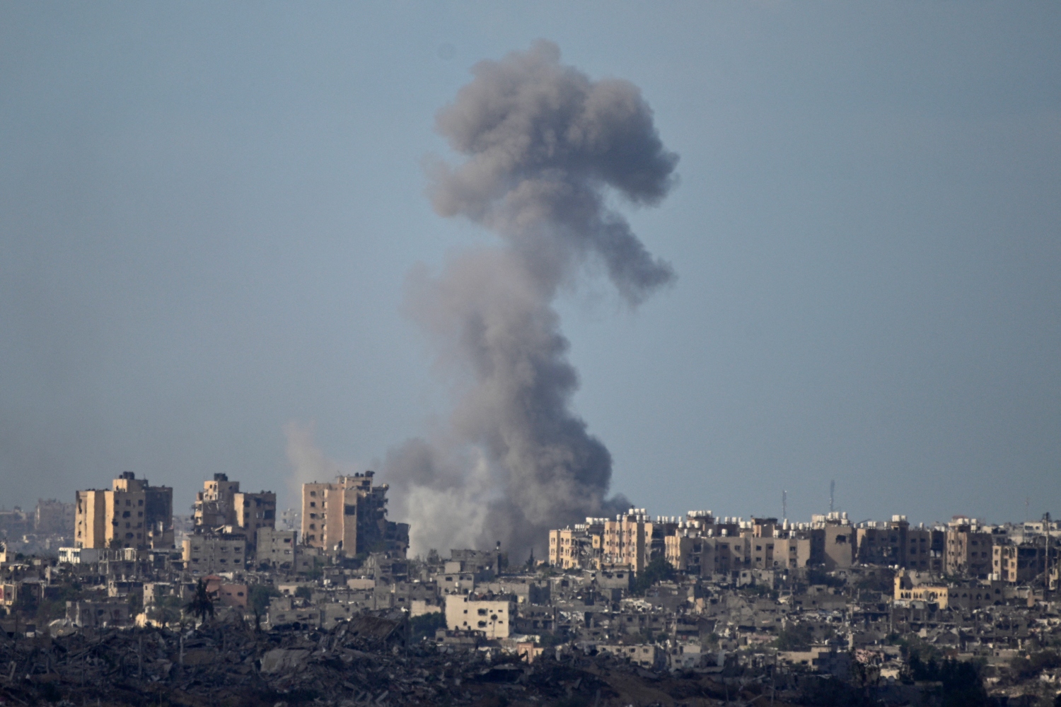 Supporting a ceasefire is simply a desperate call to stop the killing and suffering of those caught up in this war (AFP)