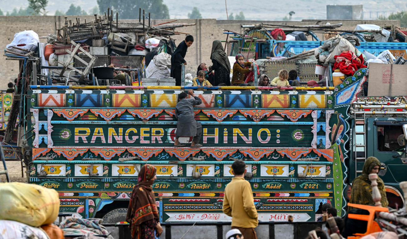 Thousands of Afghan refugees arrive at a holding centre as they prepare to depart for Afghanistan on Wednesday as a govt deadline sparks mass exodus. (AFP)