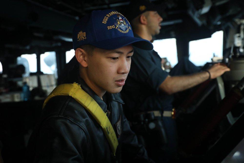 Above, a US Navy personnel stands watch on the bridge aboard the USS Rafael Peralta as it transits Taiwan Strait on Nov. 1, 2023. (X: @US7thFleet)