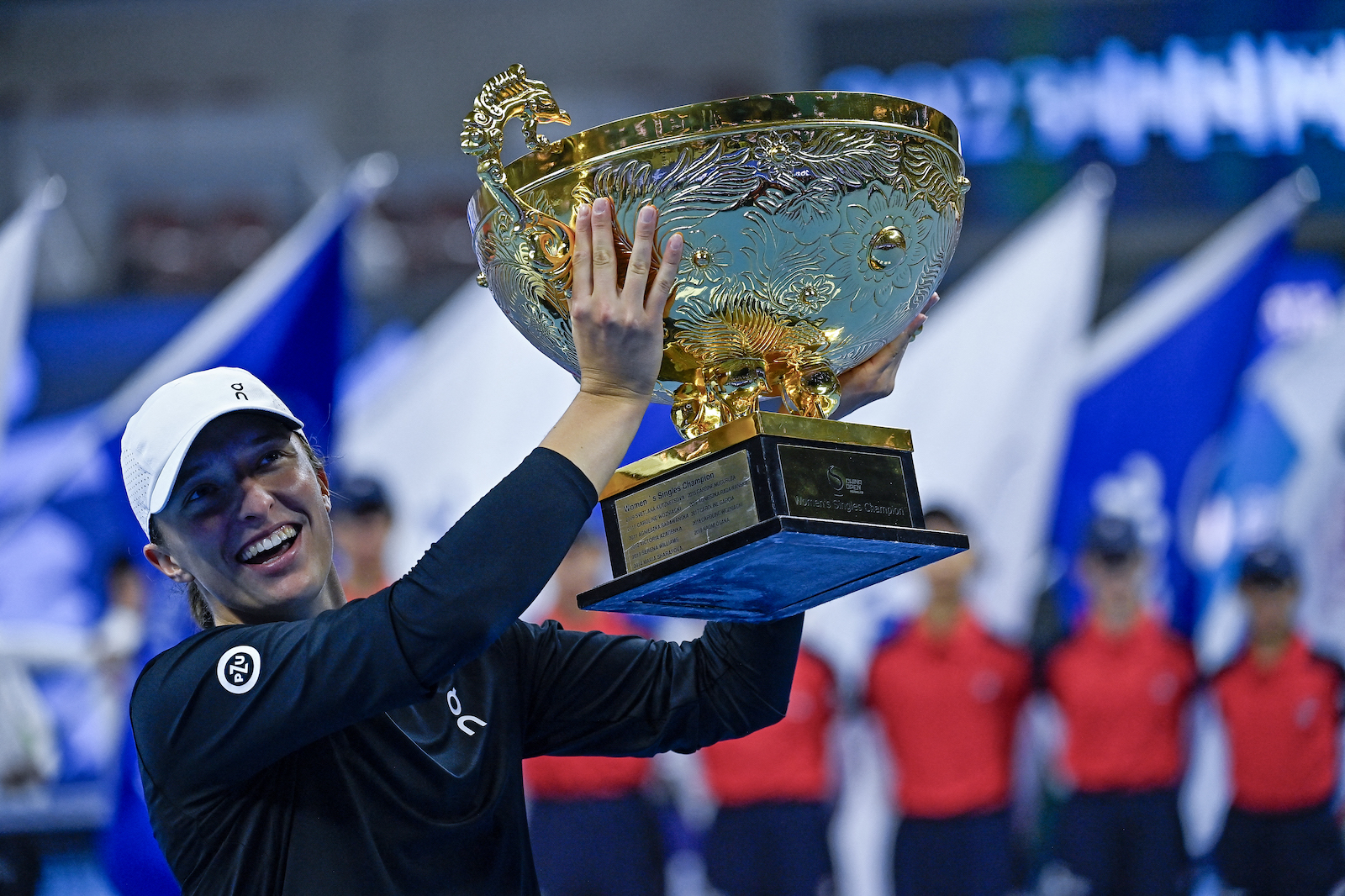 Poland's Iga Swiatek holds the winning trophy after defeating Russia's Liudmila Samsonova in the women's singles final match of the WTA China Open tennis tournament in Beijing on Oct. 8, 2023. (File/AFP)
