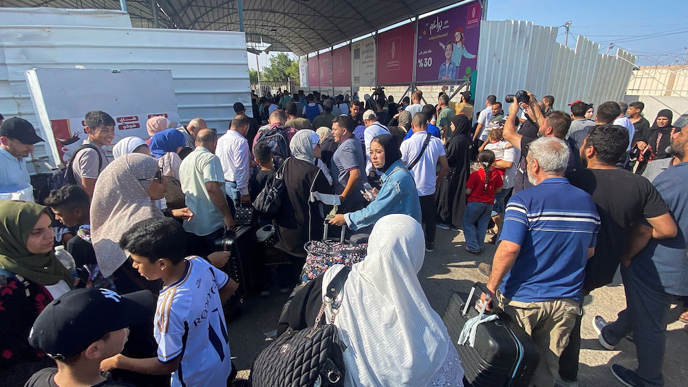 Hundreds of foreign passport holders walk through the Rafah border crossing to Egypt from Gaza in a first batch of evacuations from the besieged enclave on Nov. 1, 2023. (Reuters)